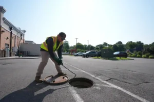 Worker performing grease trap services