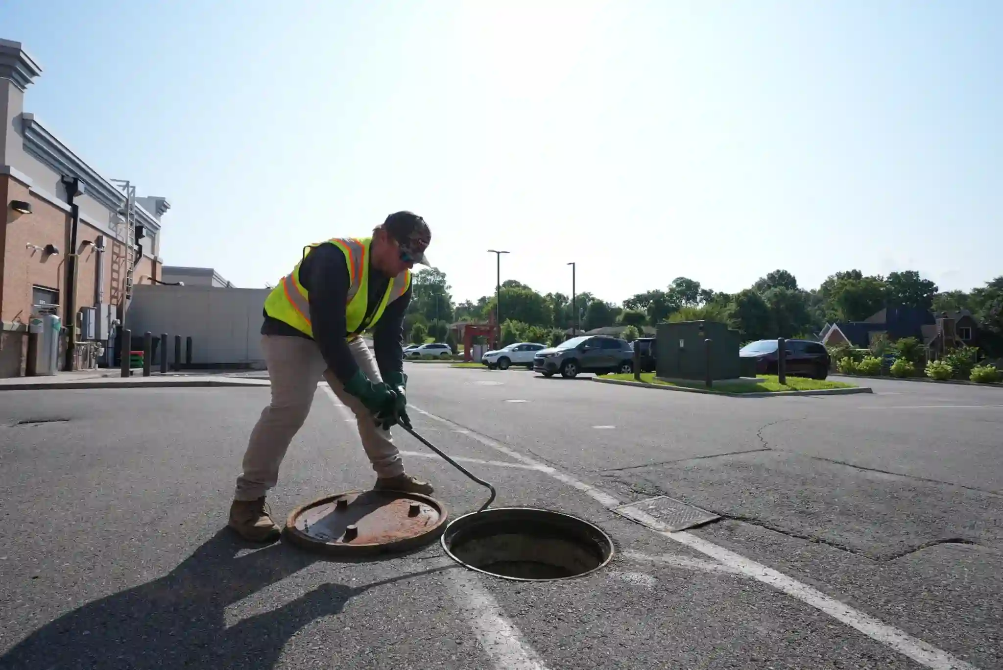 Worker performing grease trap services