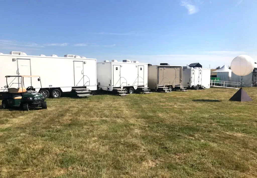 Four luxury bathroom rentals set up at an event