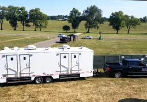 Rental restroom trailer being towed to event site