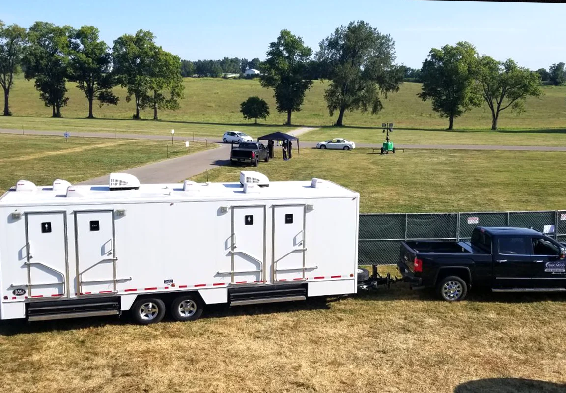 Rental restroom trailer being towed to event site