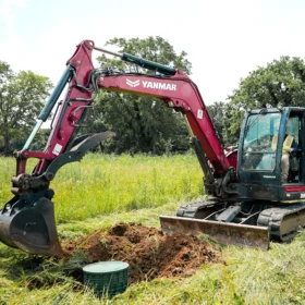 Excavator digging out a septic tank
