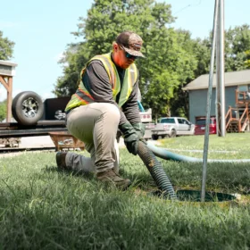 Worker performing septic pumping services