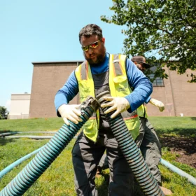 Working performing grease trap cleaning services