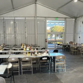 Indoor dining tent with rental tables and chairs